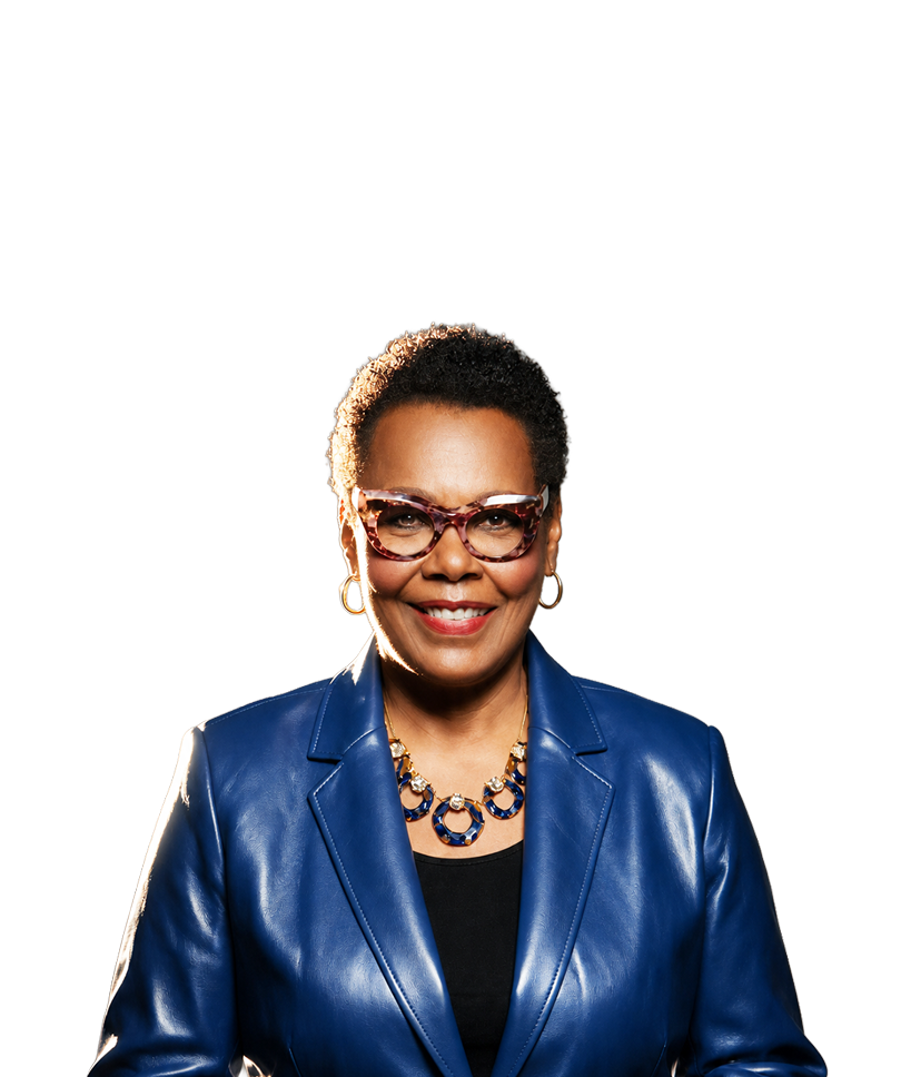 Dr. Aretha Wilson, smiling, in a blue leather jacket and tortoiseshell glasses